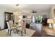 Open-concept living area featuring hardwood floors, contemporary decor, and a sliding door to the patio at 5230 Lake Arrowhead Trl # 29, Sarasota, FL 34231