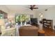 Cozy living room featuring sliding glass doors to the screened lanai and hardwood floors at 5230 Lake Arrowhead Trl # 29, Sarasota, FL 34231