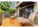 Comfortable patio with lounge chairs, umbrella, and wood railing at 5230 Lake Arrowhead Trl # 29, Sarasota, FL 34231