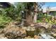 Scenic pond with rocks, stream and lush tropical foliage and landscaping at 5230 Lake Arrowhead Trl # 29, Sarasota, FL 34231