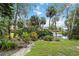 Picturesque view of a pond with fountain, trees, and landscaping at 5230 Lake Arrowhead Trl # 29, Sarasota, FL 34231