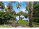 Relaxing pond view with fountain, bench, lush landscaping, and Palm Trees at 5230 Lake Arrowhead Trl # 29, Sarasota, FL 34231