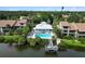 Aerial view of a community pool on a lake surrounded by lush landscaping at 5230 Lake Arrowhead Trl # 29, Sarasota, FL 34231