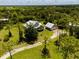Idyllic aerial view of a country home with lush landscaping and separate garage at 5242 Blackjack Cir, Punta Gorda, FL 33982