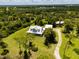 Beautiful aerial view of a home on a large lot with mature trees and greenery at 5242 Blackjack Cir, Punta Gorda, FL 33982