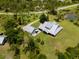 Beautiful aerial view featuring the house and garage surrounded by lush greenery at 5242 Blackjack Cir, Punta Gorda, FL 33982