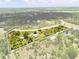 Aerial view of the property showcasing the home, surrounding land, and pond at 5242 Blackjack Cir, Punta Gorda, FL 33982