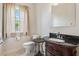 Half bathroom featuring a vanity with dark wood and a decorative mirror at 5242 Blackjack Cir, Punta Gorda, FL 33982