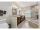 This bathroom features double sinks, granite countertops and tile flooring at 5242 Blackjack Cir, Punta Gorda, FL 33982