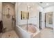 This is a bathroom with a tub next to a stand-up shower behind a glass wall at 5242 Blackjack Cir, Punta Gorda, FL 33982