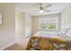 Bright bedroom with yellow-floral bedding, ceiling fan, and natural light at 5242 Blackjack Cir, Punta Gorda, FL 33982