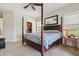 This is a large bedroom with a wooden four-poster bed and an open closet at 5242 Blackjack Cir, Punta Gorda, FL 33982