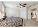 Inviting bedroom features a patterned duvet, ceiling fan and a walk-in closet at 5242 Blackjack Cir, Punta Gorda, FL 33982
