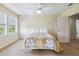 Sunny bedroom with two closets, ceiling fan, and two windows at 5242 Blackjack Cir, Punta Gorda, FL 33982