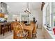 Bright dining room featuring a wood table with seating for six and views of the kitchen at 5242 Blackjack Cir, Punta Gorda, FL 33982