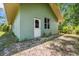 Side view of home, showing the grassy yard and a secondary entrance at 5242 Blackjack Cir, Punta Gorda, FL 33982