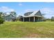 Wide view of home with screened porch and detached garage at 5242 Blackjack Cir, Punta Gorda, FL 33982