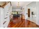 Elegant foyer featuring gleaming hardwood floors, a staircase, and an open floor plan at 5242 Blackjack Cir, Punta Gorda, FL 33982
