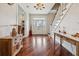 Elegant foyer with gleaming wood floors, a grand staircase, and bright, welcoming ambiance at 5242 Blackjack Cir, Punta Gorda, FL 33982