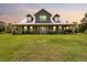 Charming home with a large yard, inviting front porch, and beautiful architectural details at 5242 Blackjack Cir, Punta Gorda, FL 33982