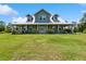 Charming home with a large yard, inviting front porch, and beautiful architectural details at 5242 Blackjack Cir, Punta Gorda, FL 33982