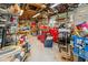 Messy garage with exposed wooden ceiling and many storage items stacked throughout at 5242 Blackjack Cir, Punta Gorda, FL 33982
