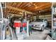 Spacious garage featuring exposed beams, room for a car and golf cart, and ample storage at 5242 Blackjack Cir, Punta Gorda, FL 33982