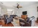 Bright living room featuring hardwood floors, a ceiling fan and comfortable leather seating at 5242 Blackjack Cir, Punta Gorda, FL 33982