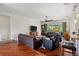 Spacious living room featuring dark hardwood flooring and comfortable furniture at 5242 Blackjack Cir, Punta Gorda, FL 33982