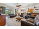 Spacious living room with dark leather furniture, ceiling fan, and an area rug at 5242 Blackjack Cir, Punta Gorda, FL 33982