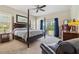 Main bedroom featuring a four poster bed, dark wood furniture, and a ceiling fan at 5242 Blackjack Cir, Punta Gorda, FL 33982