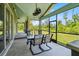 Covered porch with outdoor seating, ceiling fans, and screened windows at 5242 Blackjack Cir, Punta Gorda, FL 33982
