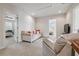 A large sitting room with white sofa and two doors leading to bedrooms at 5242 Blackjack Cir, Punta Gorda, FL 33982