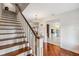Hardwood stairs, white risers and white banister; foyer with hardwood floors at 5242 Blackjack Cir, Punta Gorda, FL 33982
