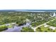An elevated view of the home surrounded by a canal and tropical greenery at 576 Mcdill Dr, Port Charlotte, FL 33953