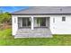 View of backyard with manicured lawn, white exterior, and outdoor kitchen at 576 Mcdill Dr, Port Charlotte, FL 33953