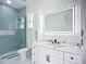 Chic bathroom featuring an LED mirror, sleek vanity with modern fixtures, and a tiled shower at 576 Mcdill Dr, Port Charlotte, FL 33953