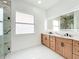 Bathroom featuring double vanity with a modern, lighted mirror at 576 Mcdill Dr, Port Charlotte, FL 33953