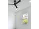Bright bedroom with a ceiling fan, a window with views, closet space and neutral decor at 576 Mcdill Dr, Port Charlotte, FL 33953