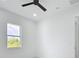 Bright bedroom with a ceiling fan, a window, and white walls at 576 Mcdill Dr, Port Charlotte, FL 33953