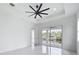 Bedroom featuring a ceiling fan and sliding glass doors to the outside at 576 Mcdill Dr, Port Charlotte, FL 33953