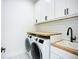Laundry room featuring washer, dryer, and a utility sink at 576 Mcdill Dr, Port Charlotte, FL 33953
