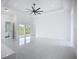 Spacious living room with sliding glass doors leading to an outdoor area, enhancing natural light at 576 Mcdill Dr, Port Charlotte, FL 33953
