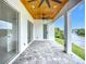 Covered outdoor patio featuring ceiling fan, pavers, and access to waterway views at 576 Mcdill Dr, Port Charlotte, FL 33953