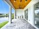 Inviting patio with a wood plank ceiling, fan, and an outdoor kitchen at 576 Mcdill Dr, Port Charlotte, FL 33953