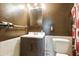 Cozy bathroom featuring a vanity with wood cabinetry and a white porcelain toilet at 6196 Mayberry Ave, North Port, FL 34287