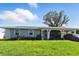 Charming single story home with a well-manicured lawn and covered parking at 6196 Mayberry Ave, North Port, FL 34287