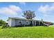 Inviting home with covered parking and a lush green front yard at 6196 Mayberry Ave, North Port, FL 34287
