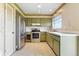 Vintage style kitchen with stainless steel appliances and speckled flooring at 6196 Mayberry Ave, North Port, FL 34287