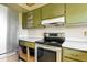 Kitchen with stainless steel refrigerator and stove with vintage cabinets at 6196 Mayberry Ave, North Port, FL 34287